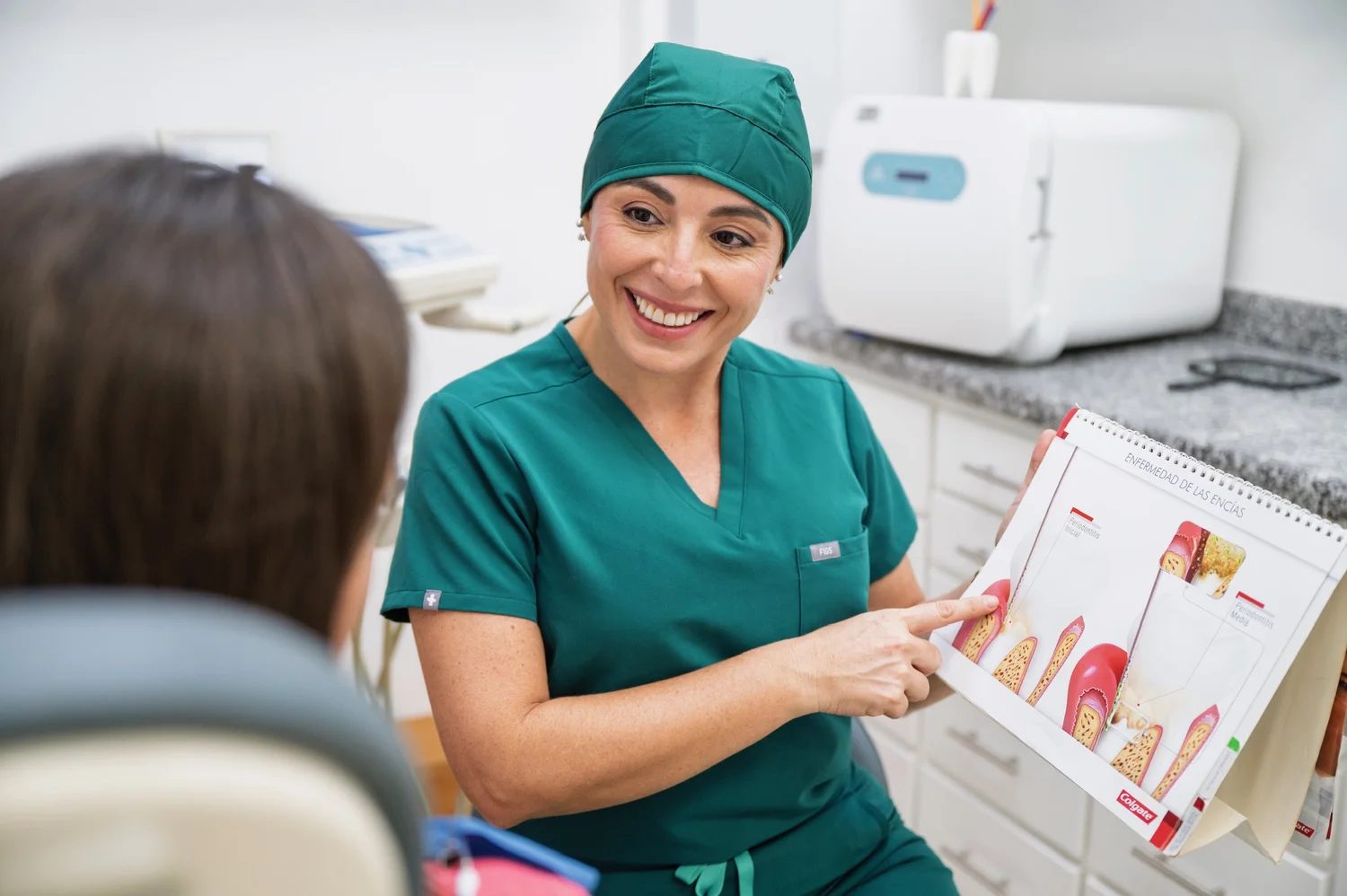 Dentist reviewing a shade guide with a patient at Armonía Vital Dental Care in Jacó