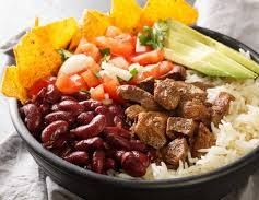 Traditional Costa Rican chifrijo bowl with white rice, red beans, meat, tomato, and avocado — popular dish in Jaco Beach