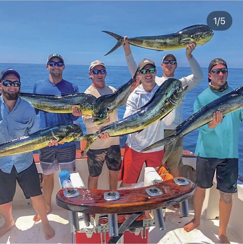 Group of anglers holding a fresh mahi-mahi catch on a sport fishing charter out of Los Sueños near Jaco Beach