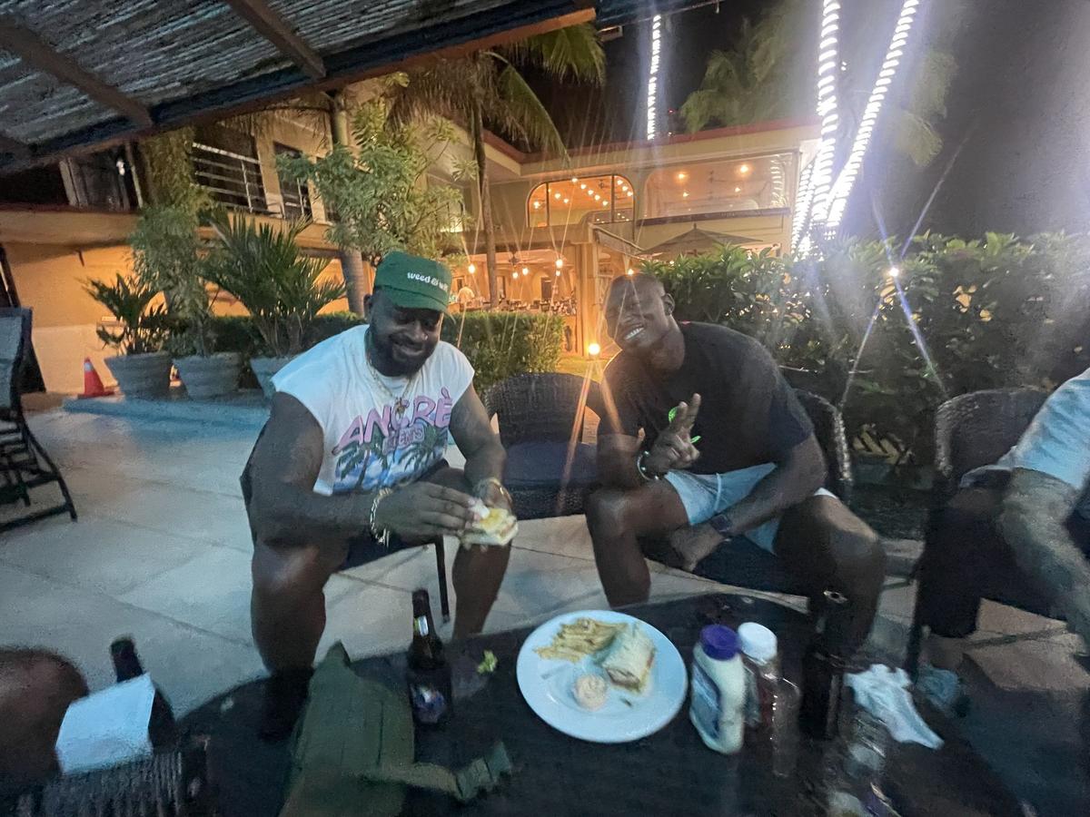 guys hanging out private villa night guys trip Jaco Beach Costa Rica villa outdoor dinner