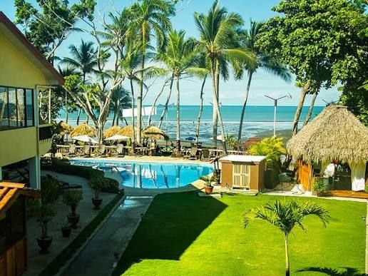 Aerial view of beachfront pool and palm gardens — Private Resort Jacó Beach Costa Rica