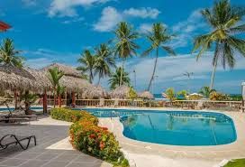 Private Resort pool at sunset with palms and Pacific Ocean — VIP Wedding Venue Jacó Beach