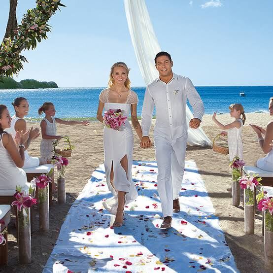 wedding planner Jaco Beach — couple celebrating at beachfront wedding arch, destination wedding Costa Rica