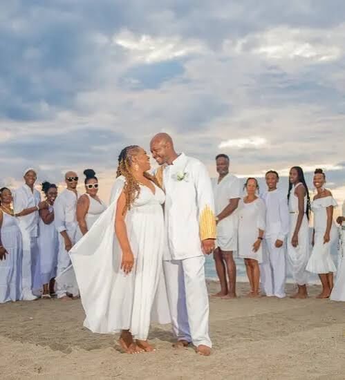 wedding planner Jaco Beach — wedding group photo at beach sunset, destination wedding accommodations Jacó Beach