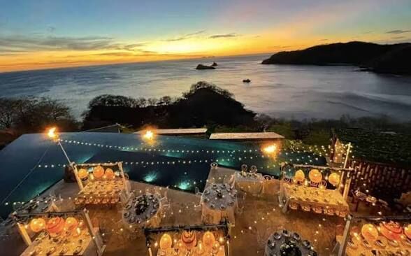 wedding planner Jaco Beach — aerial view of wedding reception at sunset, Jacó Beach Costa Rica venue cost