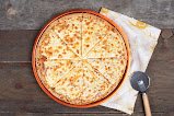 Little Caesars cheese pizza with a pizza cutter in Jacó