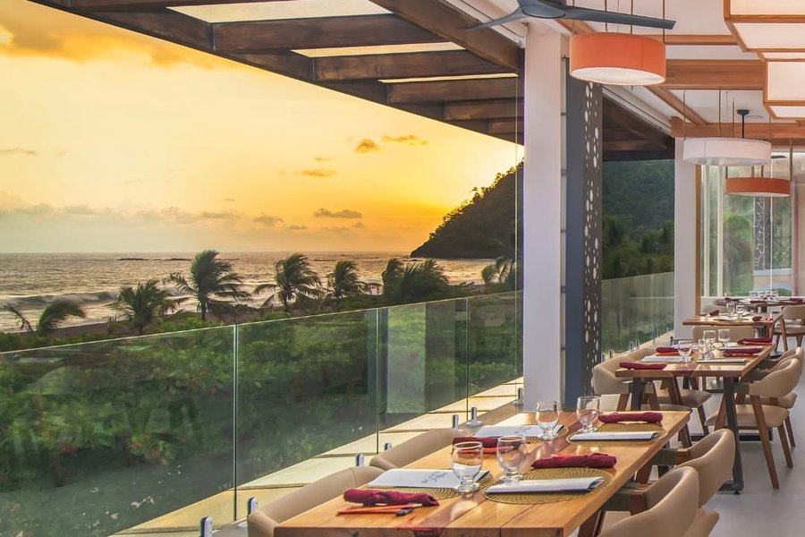 Oceanview dining terrace at Clarita's Beach Resort at sunset in Jacó, Costa Rica