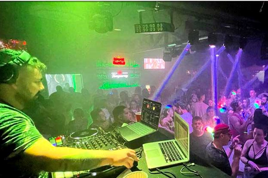 DJ under green lights at Republik Lounge