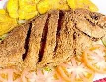 Pargo frito whole fried snapper scored and deep-fried served with patacones — popular seafood dish in Jaco Costa Rica