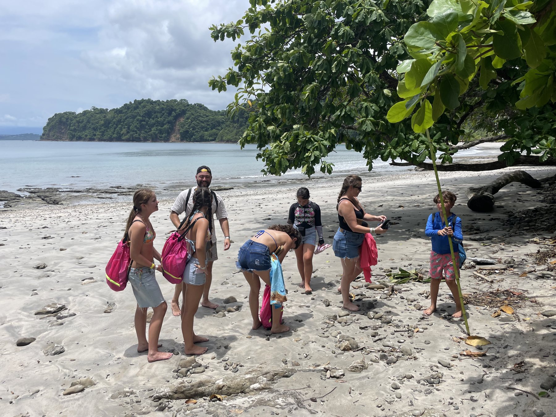 A group exploring the shoreline near Playa Mantas and Playa Blanca by the Punta Leona lot — real estate Jaco Costa Rica