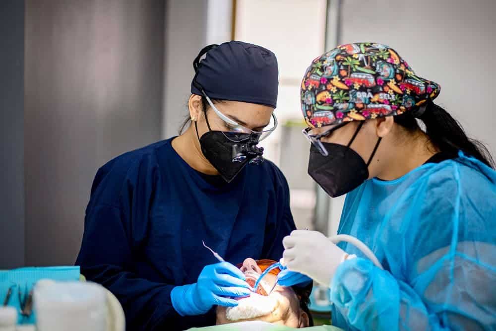 Dentists treating a patient at Premier Dental Care in Jacó, Costa Rica