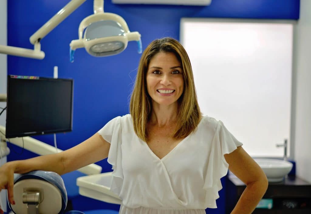 Dr. Aura Núñez, founder of Premier Dental Care Jaco, smiling in her clinic
