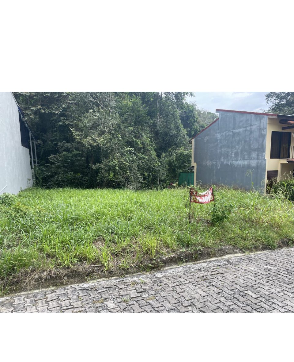 A 250 square metre building lot for sale between two houses in a gated Punta Leona community near Jaco