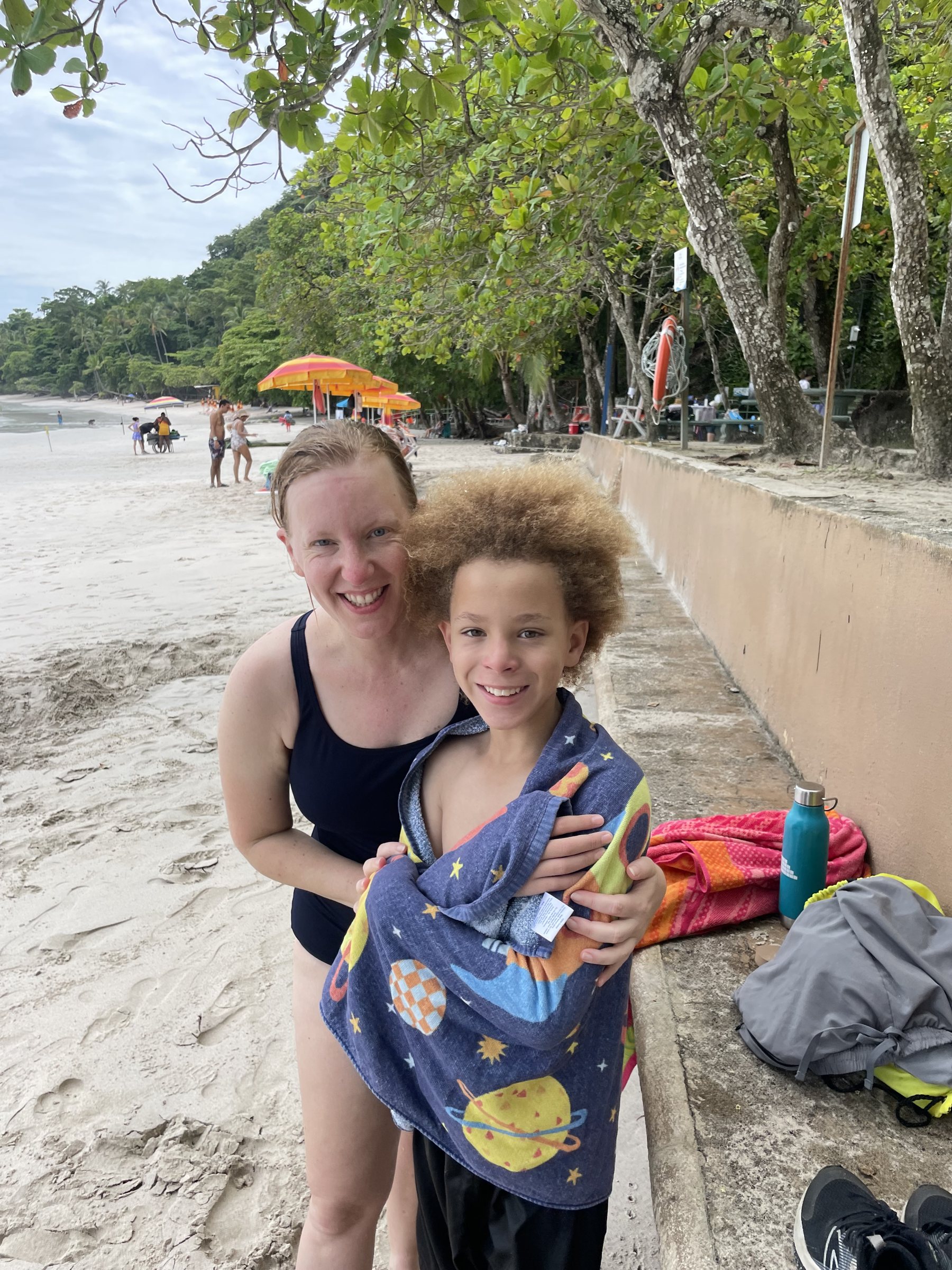 Family enjoying the calm beach near the Punta Leona real estate lot