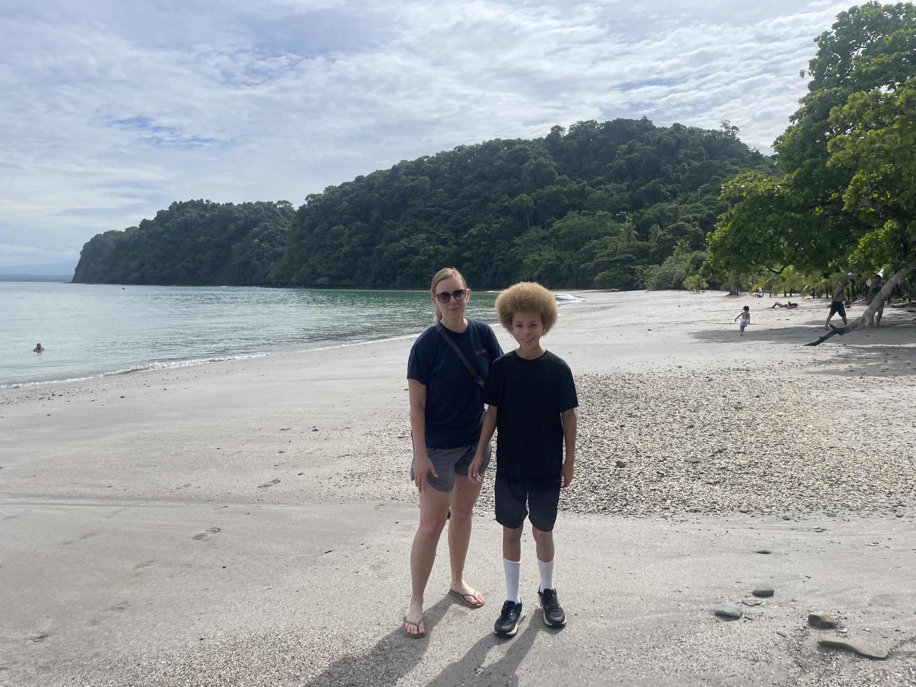 Forested headland and calm turquoise water at Playa Mantas near Jaco