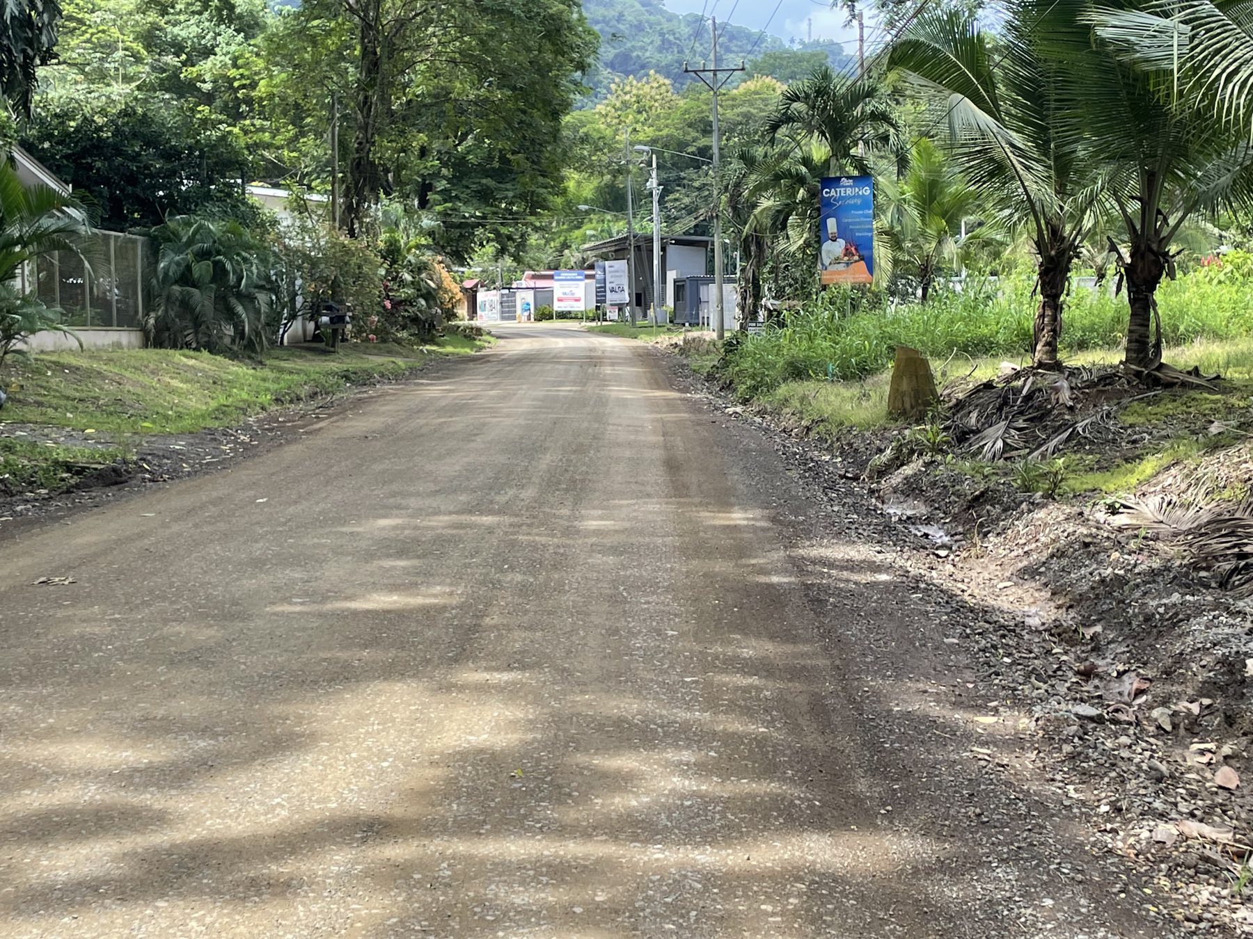 The paved road along the 225 square metre lot for sale near Playa Mantas — real estate Jaco Costa Rica with utilities at the road