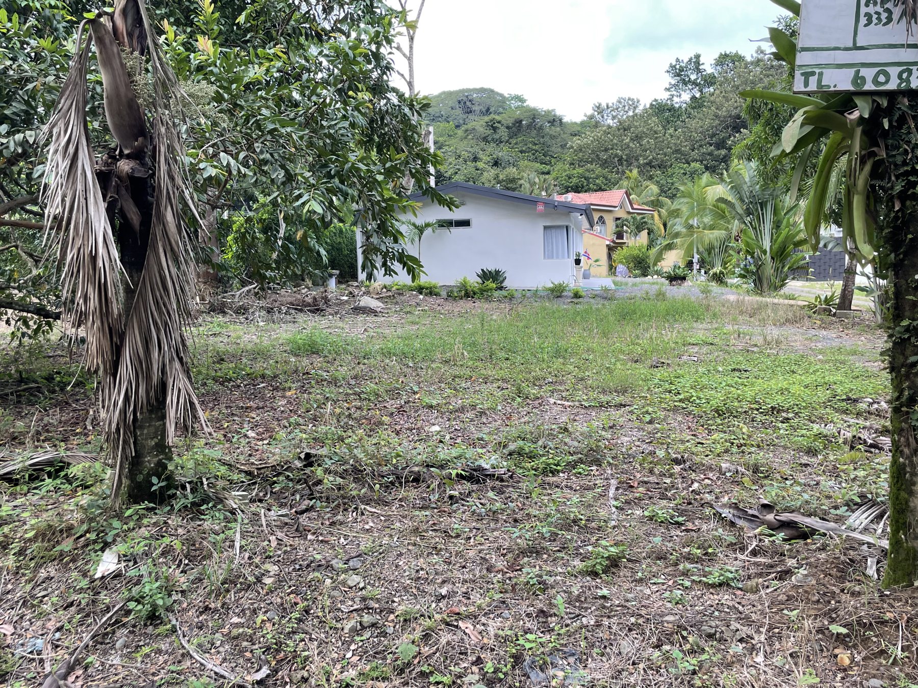 A 333 m² cleared building lot for sale half a mile from Playa Mantas near Jaco Beach, with a green mountain backdrop — best priced real estate near Jaco Beach, Costa Rica