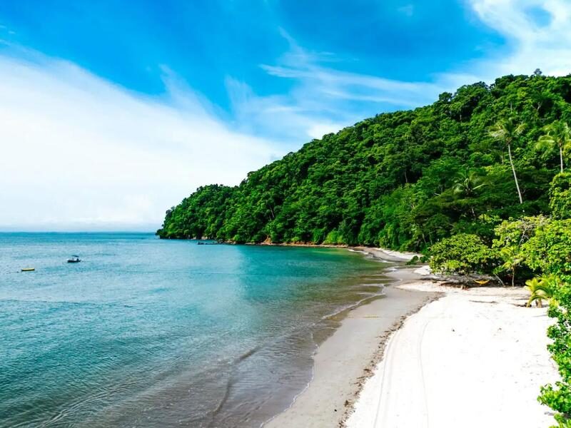White-sand beach and turquoise water at Playa Blanca near Punta Leona — best properties near Jaco Beach, Costa Rica