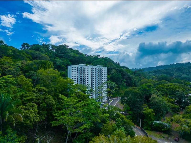 Aerial view of a luxury residential complex rising from lush rainforest near Playa Blanca at Punta Leona — real estate for sale near Jaco Beach, Costa Rica