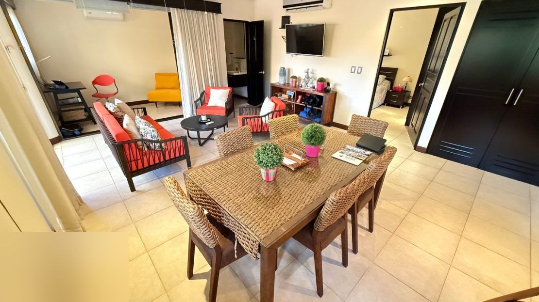 Open-plan dining and living room in the Sitio de Ensueno villa, Punta Leona — Jaco Beach real estate, move-in ready furnished home