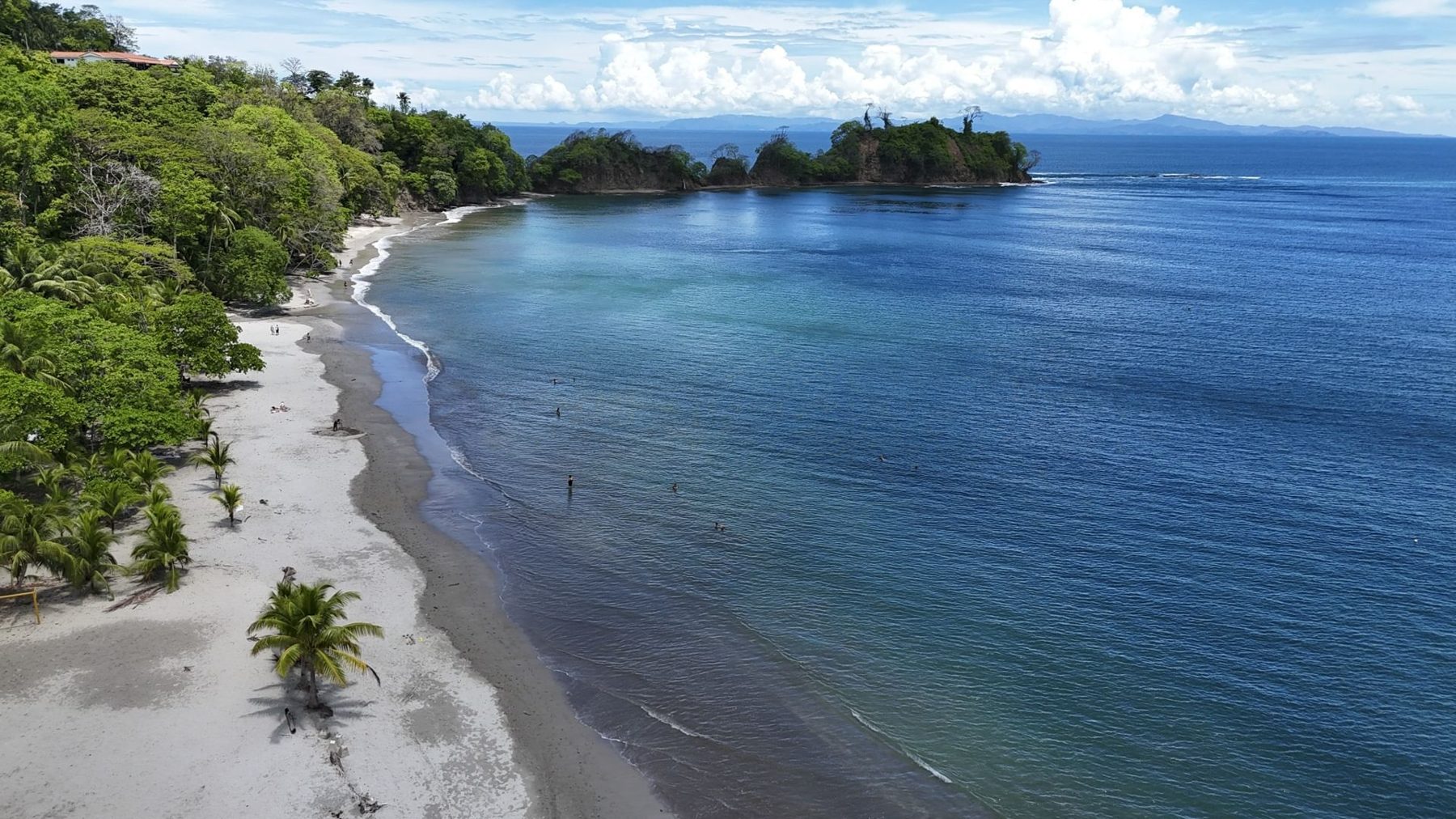 Calm bay with a palm-covered point at Punta Leona near Jaco Beach