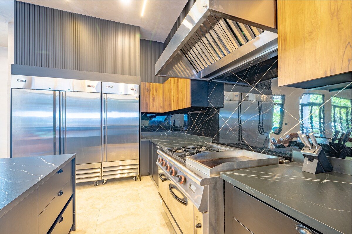Casa VIP 2 — 15-bedroom beachfront estate in Jacó Beach, floor-to-ceiling glass onto the pool