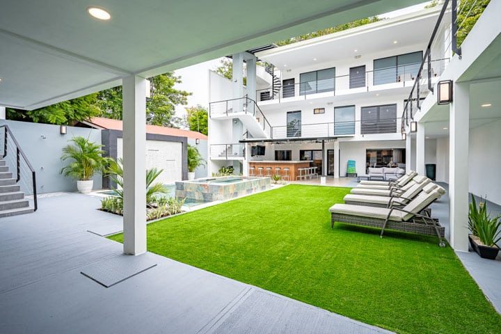 Casa VIP 5 — 13-bedroom beachfront villa in Jacó Beach, back lawn and villa