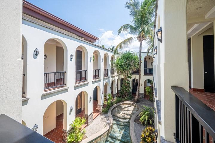 Casa VIP 7 — 9-bedroom beachfront villa in Jacó Beach, arched interior with courtyard light