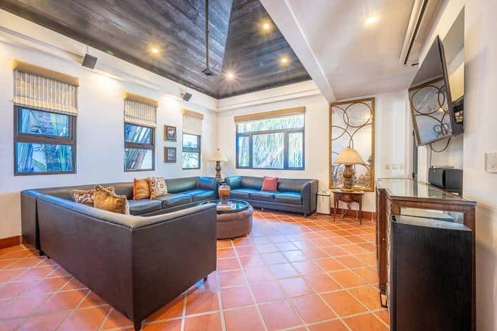 Casa VIP 7 — 9-bedroom beachfront villa in Jacó Beach, courtyard seating under the trees