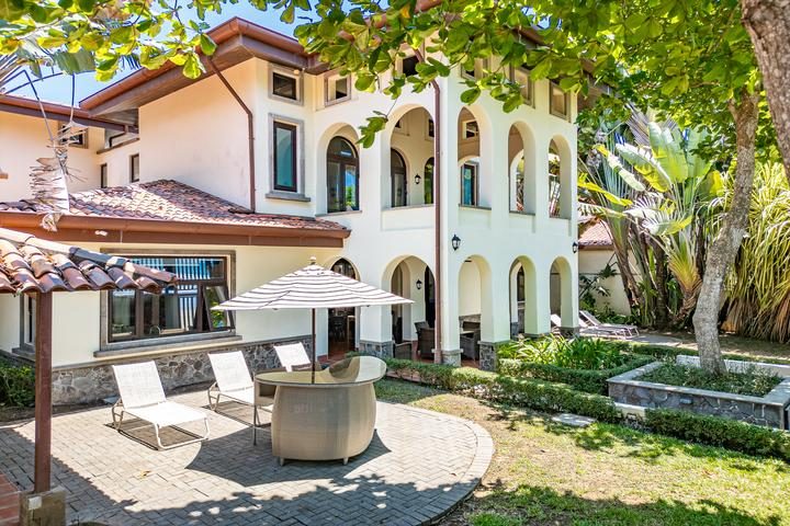 Casa VIP 7 — 9-bedroom beachfront villa in Jacó Beach, villa exterior with patio loungers