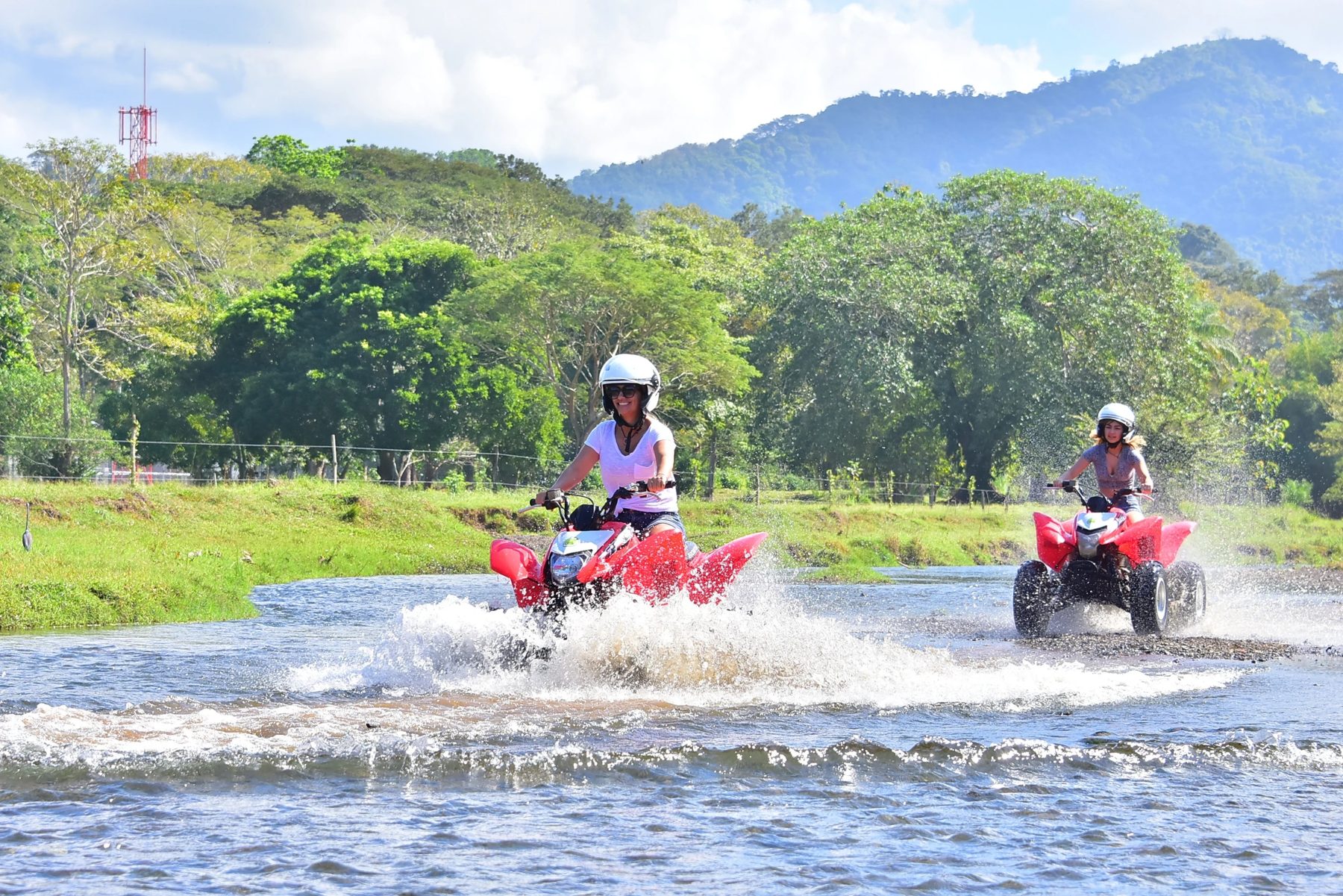 ATVs splashing through a river in Costa Rica