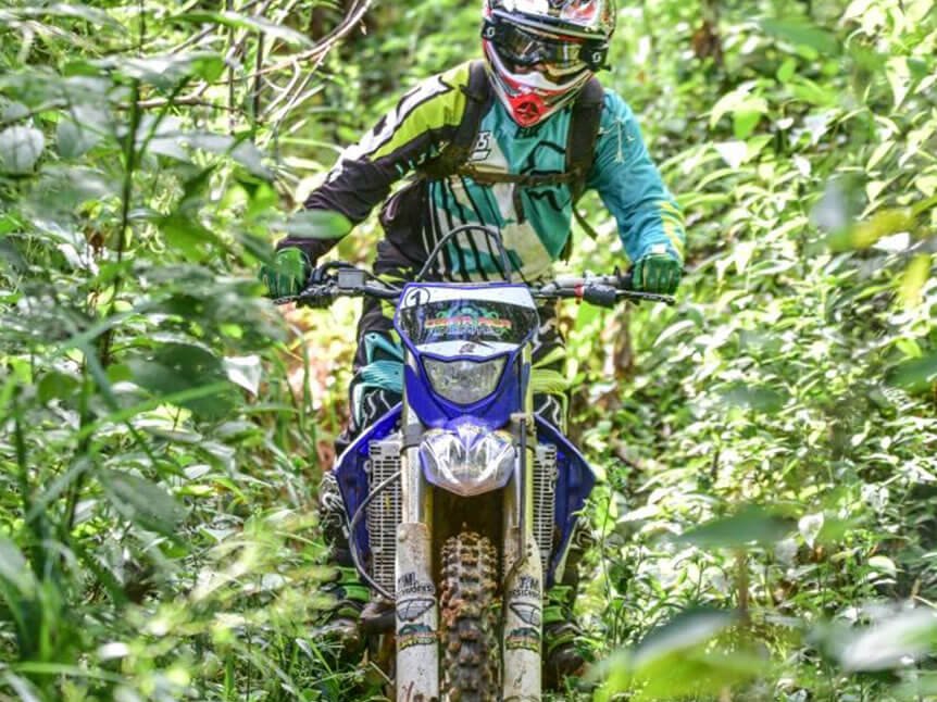 Rider on a jungle single-track trail