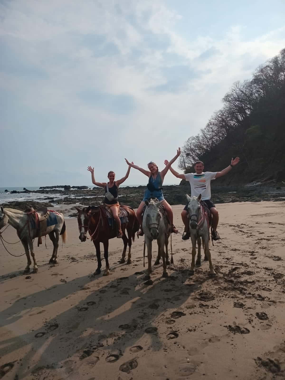 Riders on horseback along the beach in Costa Rica