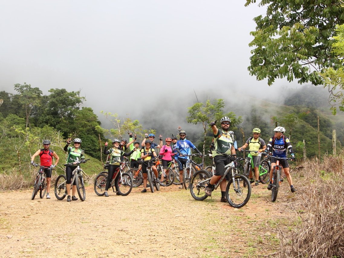 Group of mountain bikers on a misty mountain road