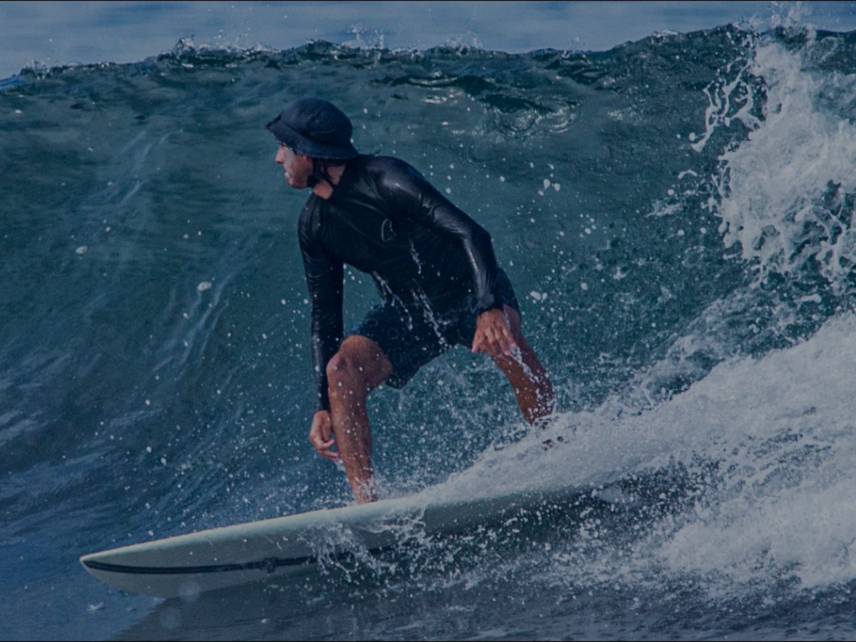 Surfer riding a wave at Jacó Beach