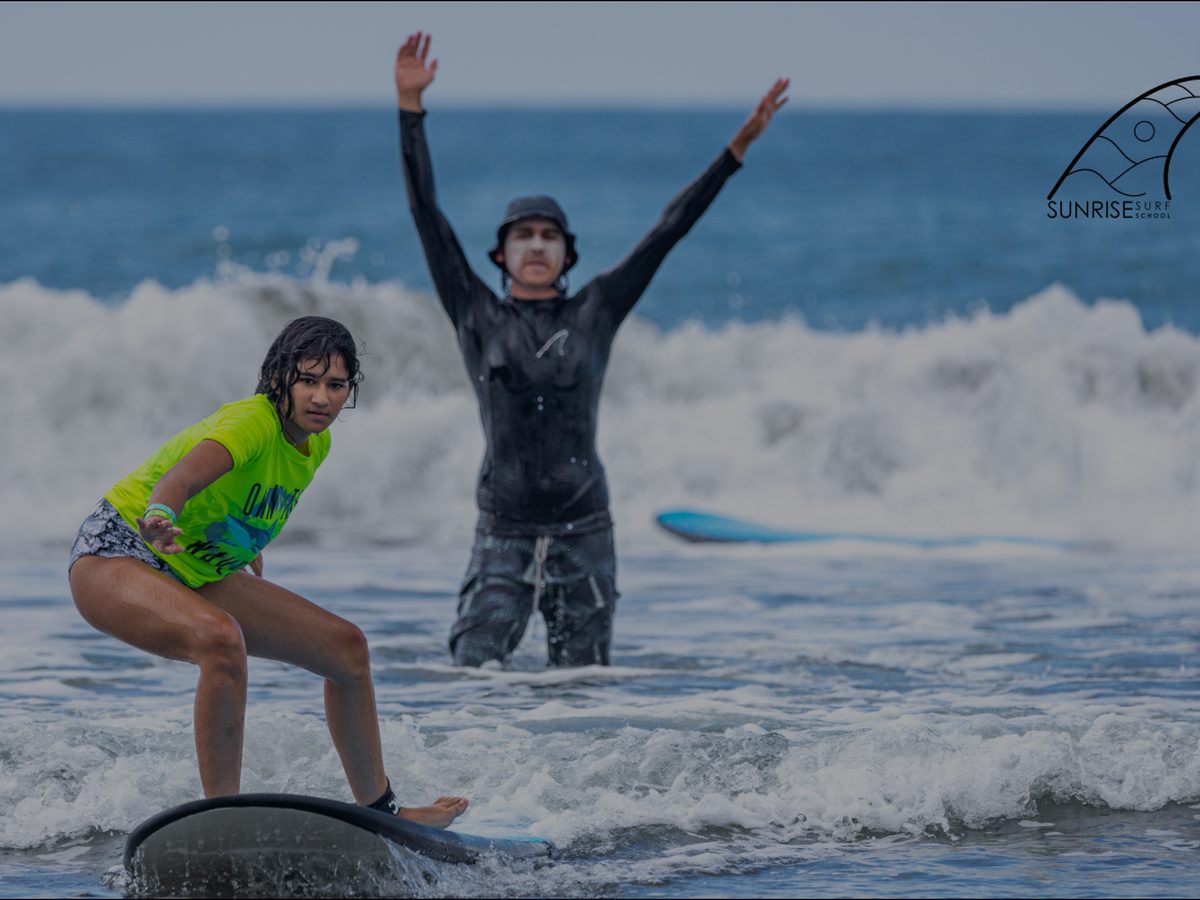 Young surfer celebrating a first wave in Jacó
