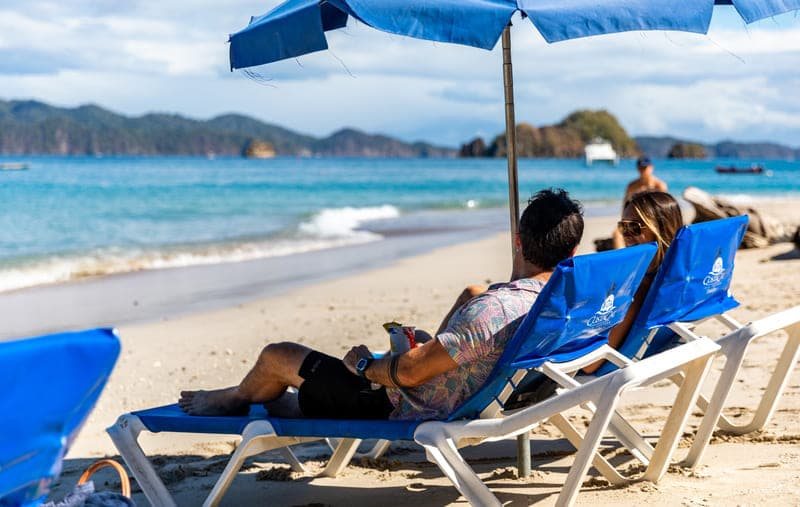 Beach loungers and umbrellas on Tortuga Island's white sand